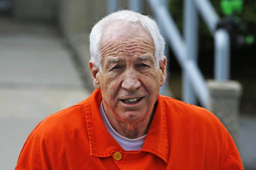 Sadusky wearing prison orange.