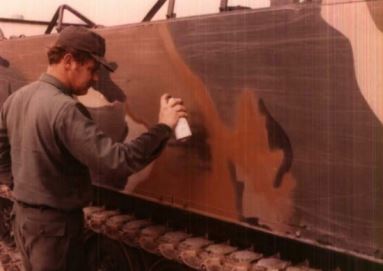 soldier paints a tank